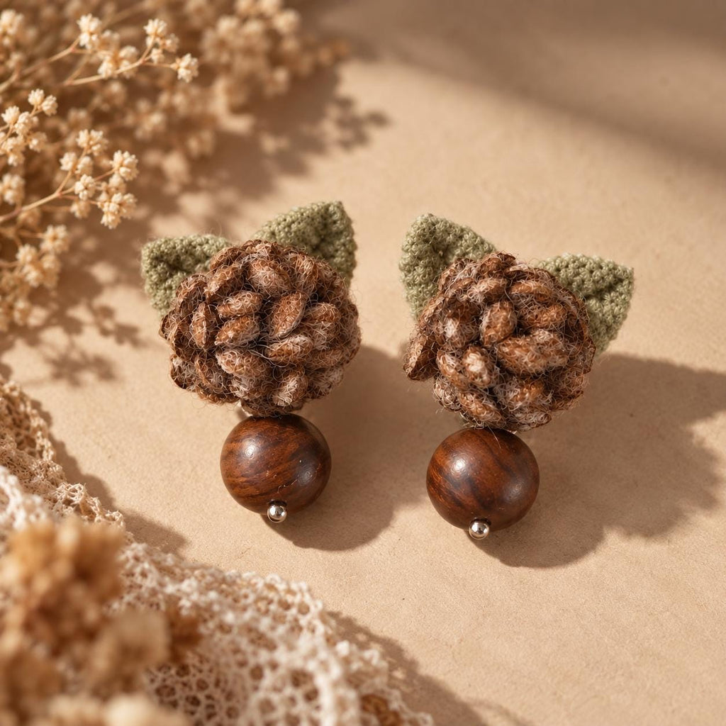 Pair of Hazelwood crochet-flower earrings arranged on a pale stone slab.