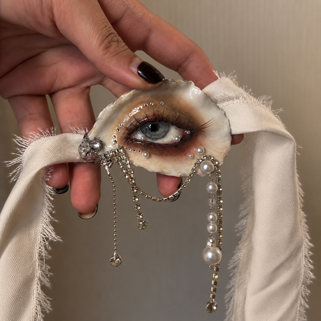 Sereine Eye LV027 — handheld view with ivory ribbon