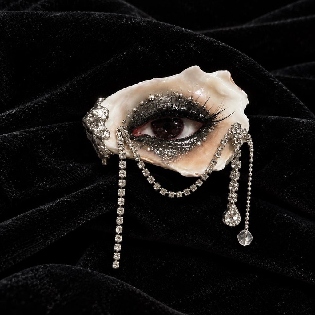 LV029 — deep red oyster eye with dramatic black lashes, faux pearl accents and cascading rhinestone chains on black velvet