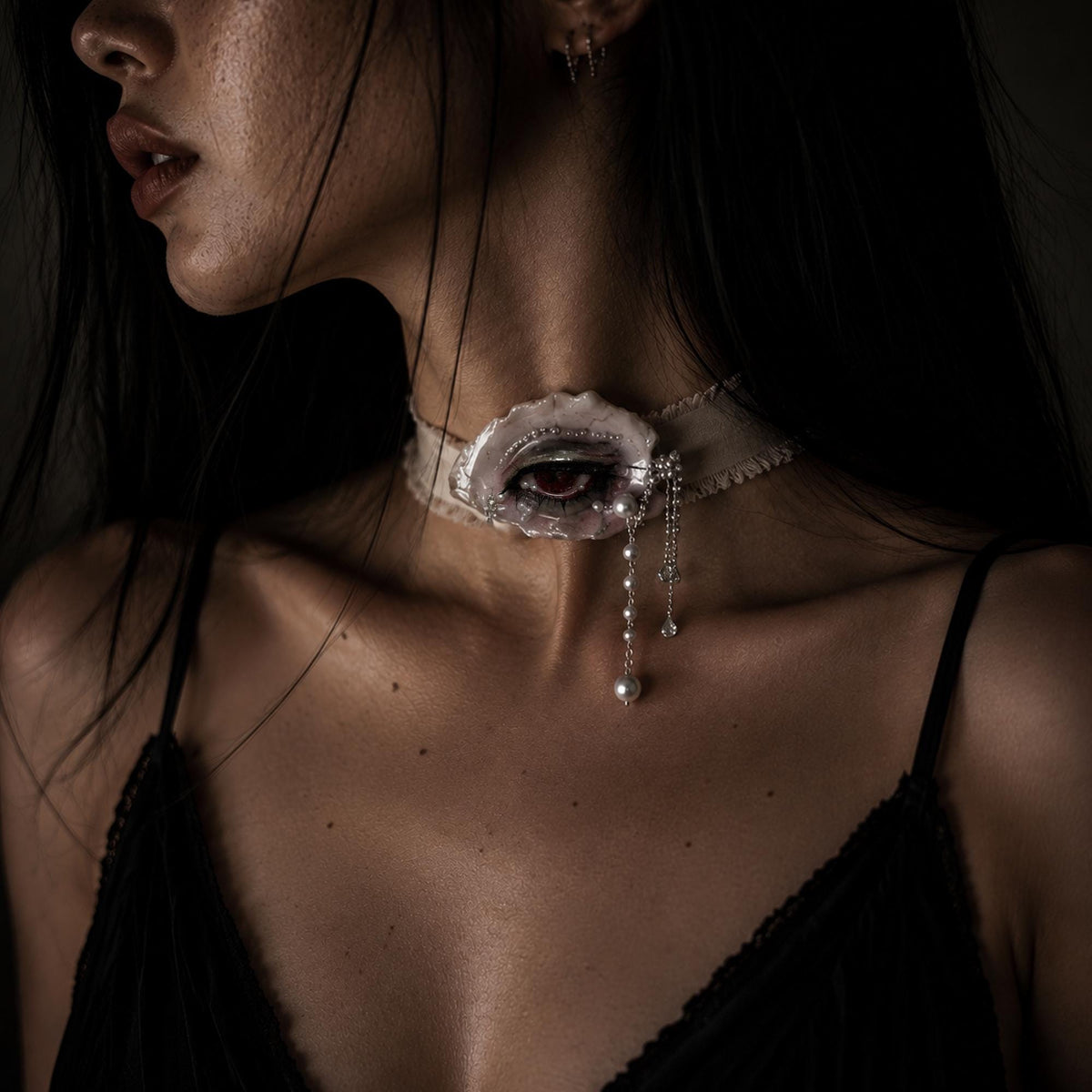 Modeled close-up wearing Lilith Veil on a black velvet choker